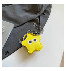 Detail of a bright yellow star-shaped mini crossbody bag with playful eye graphics