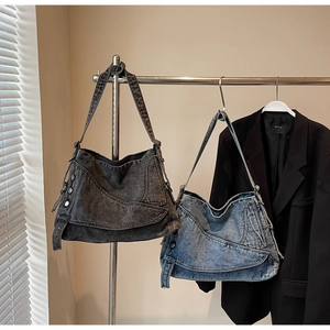 Detail of vintage denim tote bags in light blue and dark grey with metal button accents
