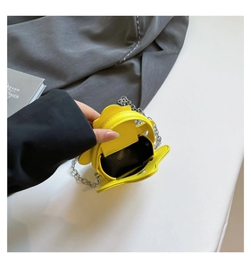 Top view of yellow star-shaped mini bag with open interior and silver chain strap