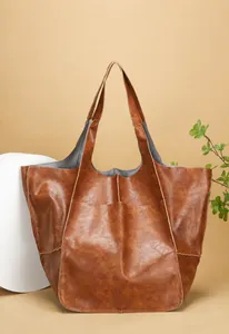 Close-up of brown vintage soft leather tote bag with retro textures for office commute