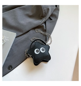 Detailed view of star-shaped mini crossbody bag featuring pebbled leather and eye design
