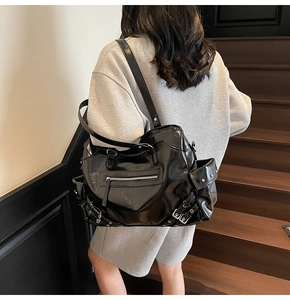 Detailed back view of a black glossy punk tote bag with silver rivets and zippers