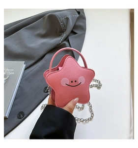 Close-up of pink star-shaped mini bag with litchi texture and metal chain strap