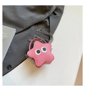 Close-up of pink star-shaped crossbody bag with cartoon eyes and silver chain strap