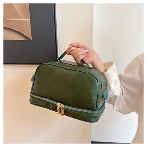 Detail of vintage dark green large makeup bag with a double-layer storage design