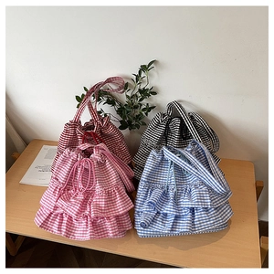 Detail showing four layered ruffle checkered canvas tote bags in red black pink and blue