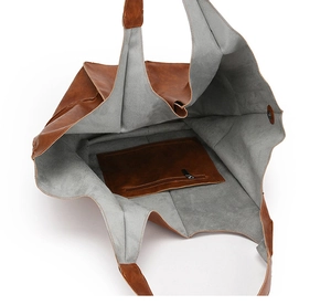 Detail view of the retro brown tote bag featuring a spacious gray interior with a zip pocket