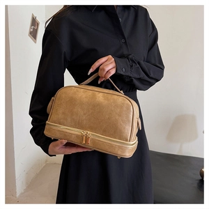Detail of vintage khaki double-layer cosmetic bag with reinforced handle and large capacity