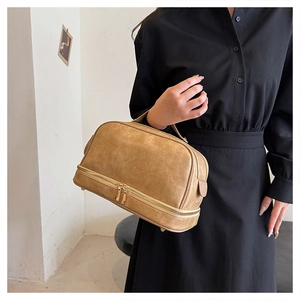 Detail view of khaki PU leather makeup bag showing dual layers and metal base studs