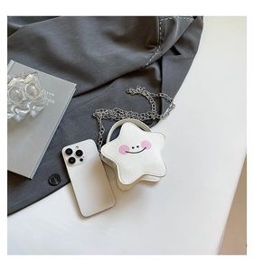 Close-up of white star-shaped mini crossbody bag with leather texture and silver chain