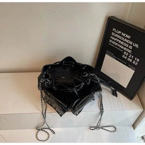 Detailed interior of a black waterproof bucket bag with silver studs and chain strap