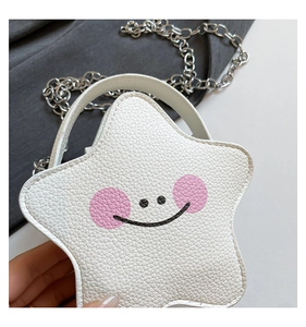 Close-up of a white star-shaped mini bag with textured leather and a cute smiley face