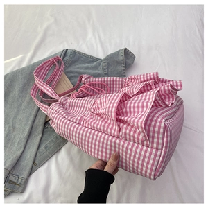 Close-up of pink and white checkered canvas tote bag featuring drawstring and ruffle details