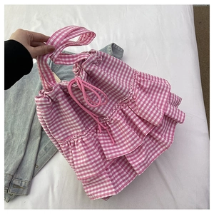 Detailed view of pink gingham tote bag featuring ruffled edges and drawstring closure