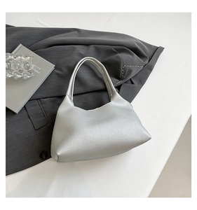 Detailed macro view of the silver lychee grain leather texture on this trendy handbag