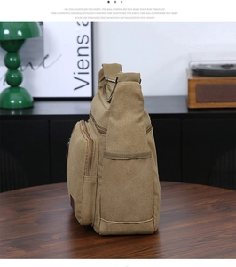 Detail of khaki canvas messenger bag with pockets in a retro vintage studio setting