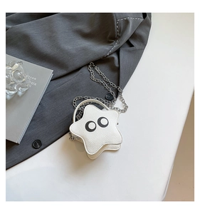 Detail of star-shaped mini bag in white lychee leather with silver chain and eye decals