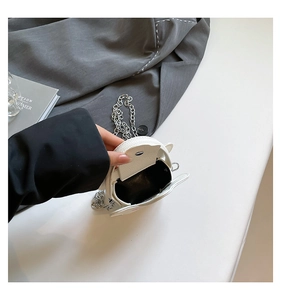 Close-up of mini white star bag with silver chain and magnetic snap closure interior