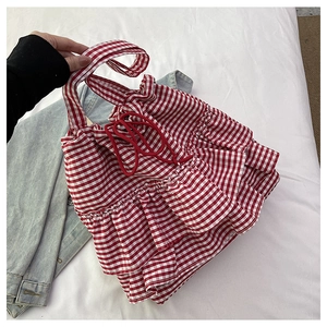 Detail of red and white checkered canvas tote bag with ruffled layers and drawstring