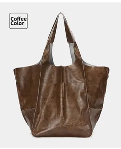 Detail view of coffee-colored tote bag showing vintage leather texture and stitching