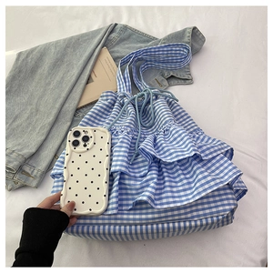 Detailed shot of blue and white checkered bucket bag with layered ruffle edge design