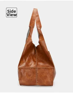 Side view detail of retro brown faux leather tote bag with premium stitching and texture