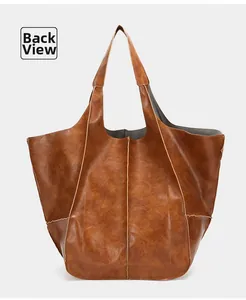 Detailed back view of large brown vintage tote bag showing soft leather texture and stitching