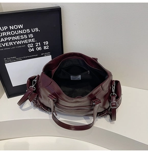 Deep burgundy tote bag featuring a spacious interior with zipper pocket and white brand label