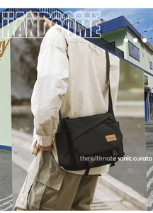 Detail of black tactical messenger bag featuring adjustable straps and buckle closures