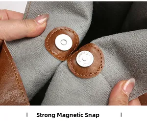 Close-up of the strong magnetic snap closure on the brown leather tote bag