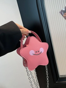 Pink star shaped mini crossbody bag with a smiling face and elegant silver chain strap