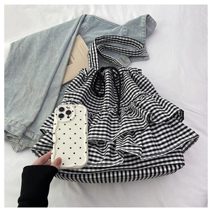 Detail view of black and white checkered drawstring tote bag with multi-layer ruffles