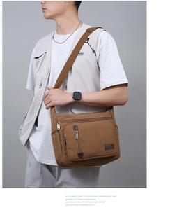 Close-up of brown canvas crossbody bag showing durable texture and zipper pockets