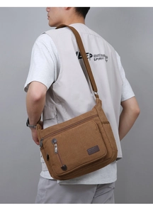 Close-up of vintage brown canvas messenger bag with durable strap and multi-pocket design
