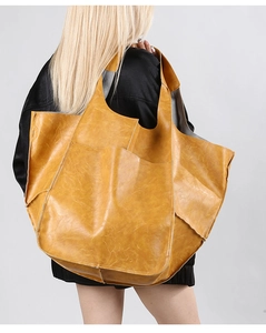 Rear view of a large ginger yellow soft leather tote bag showing oversize capacity and texture