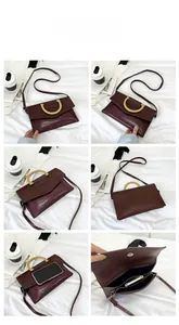 Detail of burgundy crocodile pattern handbag showing interior space and metal handle