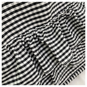 Detailed view of the black and white gingham canvas fabric with layered ruffles