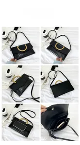 Detail view of black crocodile pattern crossbody bag with multiple inner compartments