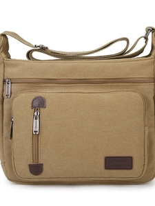 Men's khaki canvas crossbody bag with multi-zipper layers and dark brown leather trim
