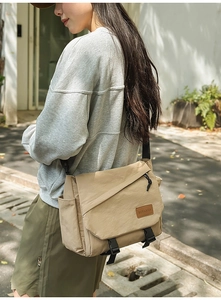 Detail view of the khaki techwear messenger bag featuring durable nylon and side pockets