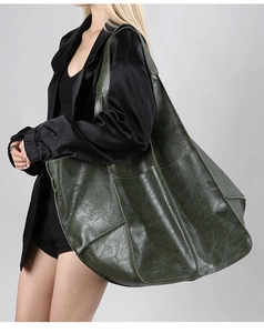 Detail view of large dark green vintage leather tote bag showing spacious multi-pocket design