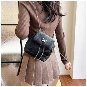 Detail of velvet mini backpack with silver butterfly logo and delicate chain fringes