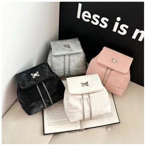 Mini velvet backpacks in four colors featuring metallic butterfly clasps and chain straps