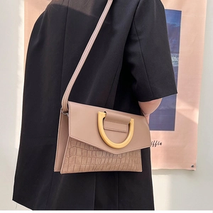 Detailed back view of a light khaki crocodile texture crossbody bag with gold metal buckle