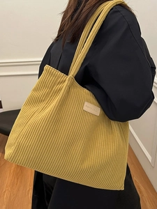 Large yellow corduroy tote bag for women with wide ribbed texture and shoulder straps
