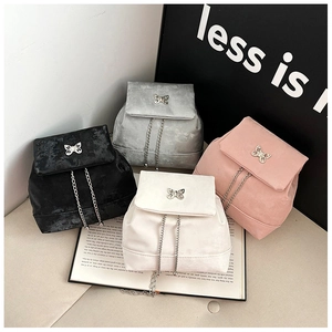 Detail of mini backpacks with metal butterfly buckles in black, grey, pink, and white