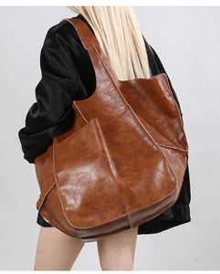 Rear view of model wearing a large vintage brown tote bag with premium oil wax leather texture