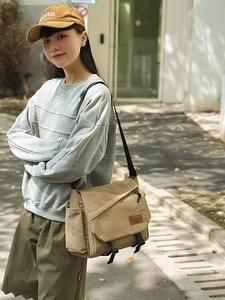 Men's khaki messenger bag in techwear style with adjustable strap and buckle closure