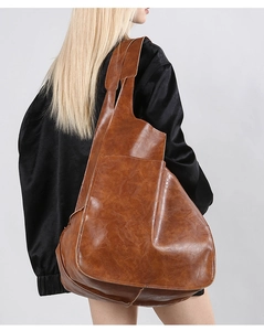 Detailed close-up showing the vintage brown waxed leather texture and soft tote silhouette