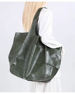 Detail of soft green vintage leather tote bag showing large capacity and stitching details